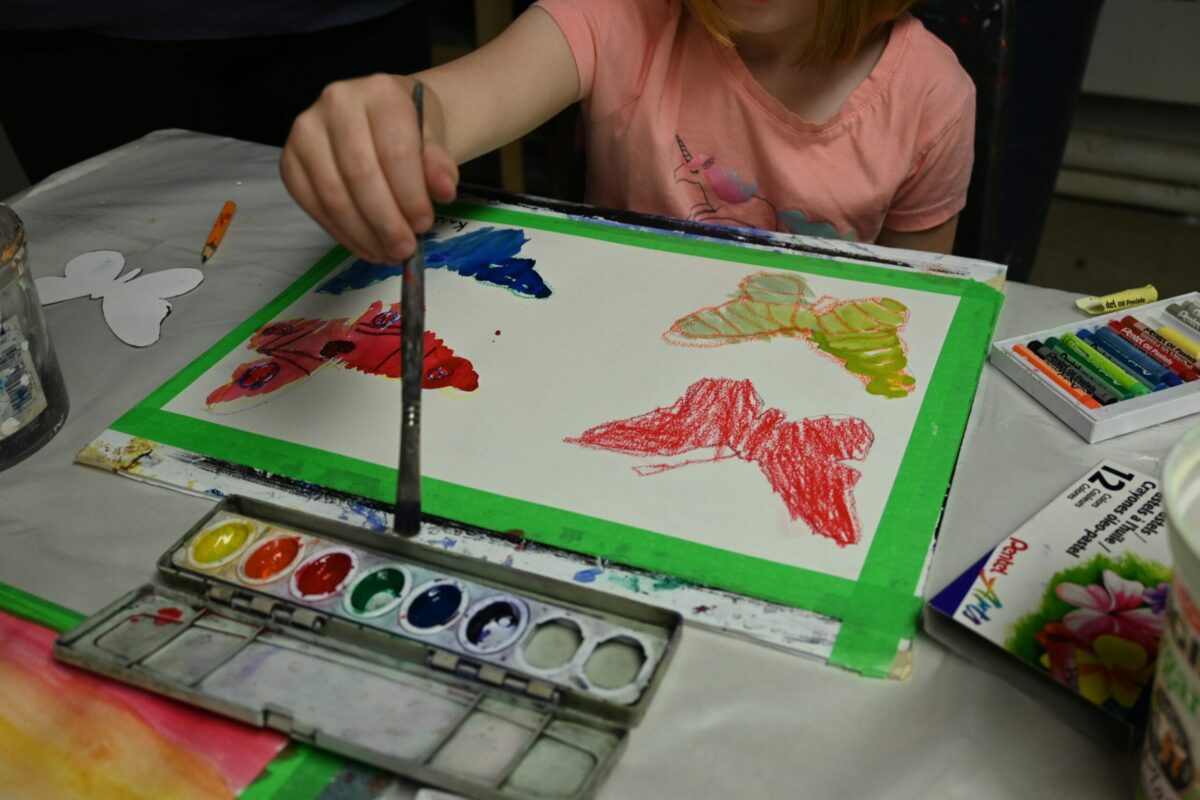 Youth art student painting with watercolours.