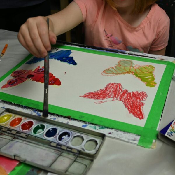 Youth art student painting with watercolours.